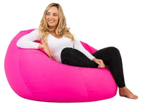 Woman sitting on a pink bean bag chair against a white background