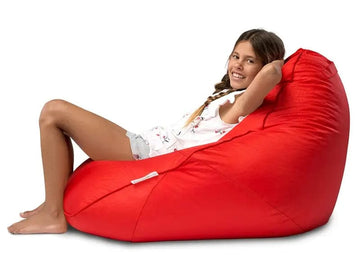 Person sitting on a red bean bag chair against a white background