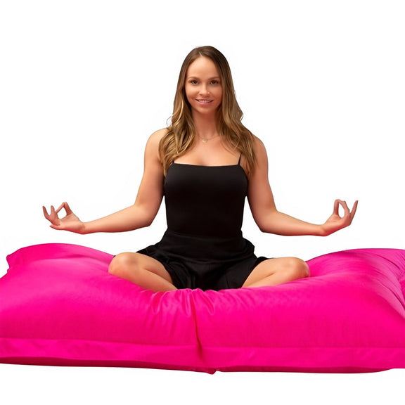 lady doing yoga pose on pink beanbag